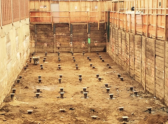 THE PULLDOWN PILE WAS TESTED TWICE AND FAILED. STELCOR WAS TESTED TO 40 KIPS (31 WAS REQUIRED). THE PILE COUNT WAS REDUCED FROM FROM 114 TO 72.